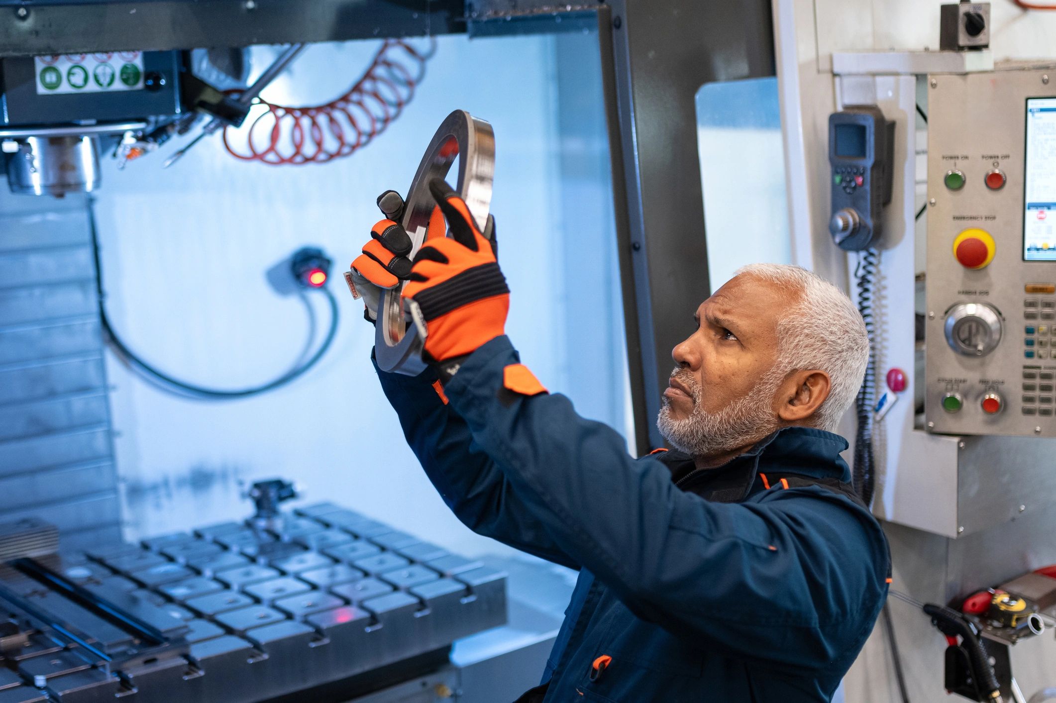 Engineer reviewing precision component inspection at a coordinate measuring machine